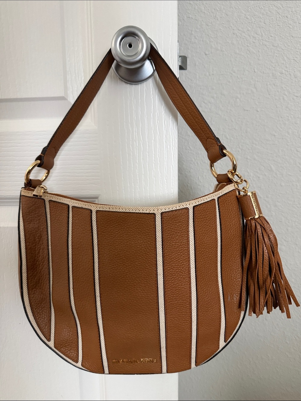 Stylish tan leather shoulder hobo by Michael Kors worn a couple times.
